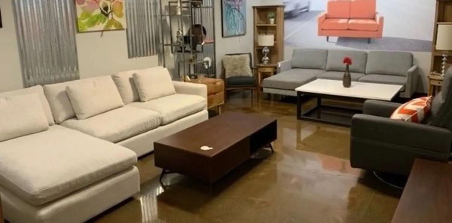 A living room filled with furniture and a large window.