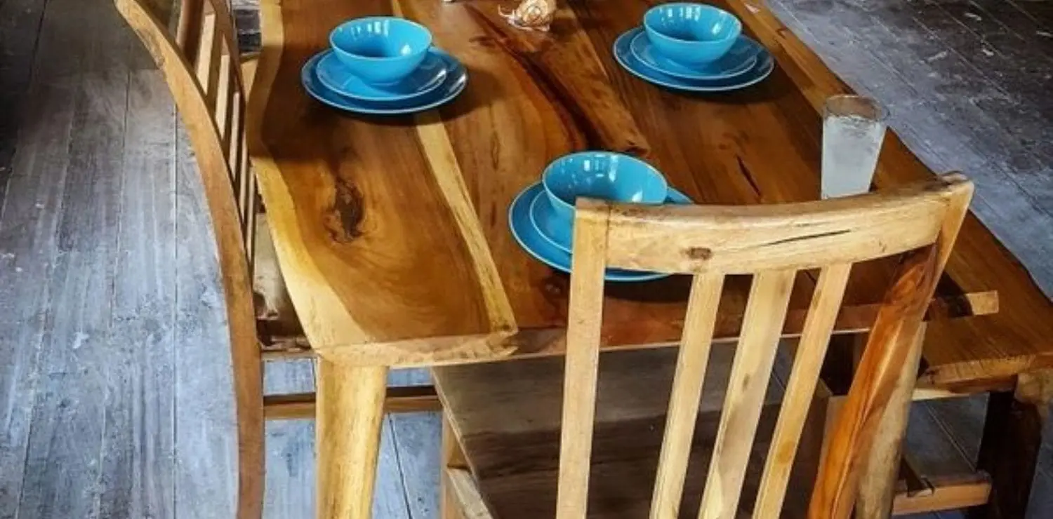 A wooden table with blue dishes on top of it.